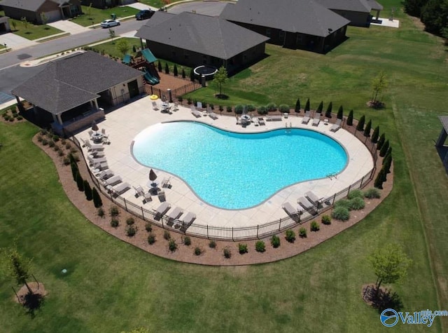 pool with a yard, a patio area, and fence