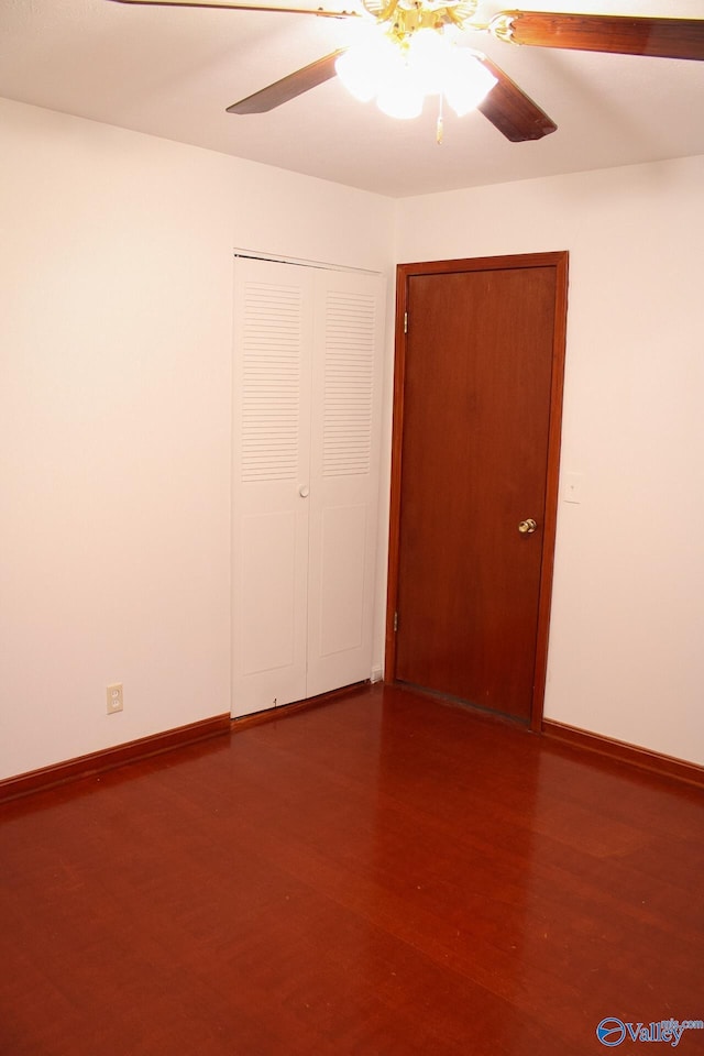 empty room with dark hardwood / wood-style flooring