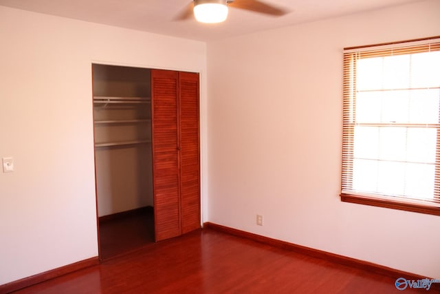 unfurnished bedroom featuring wood-type flooring, a closet, and ceiling fan