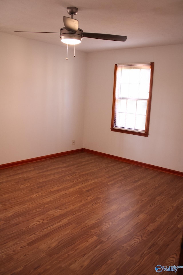 empty room featuring dark hardwood / wood-style floors and ceiling fan