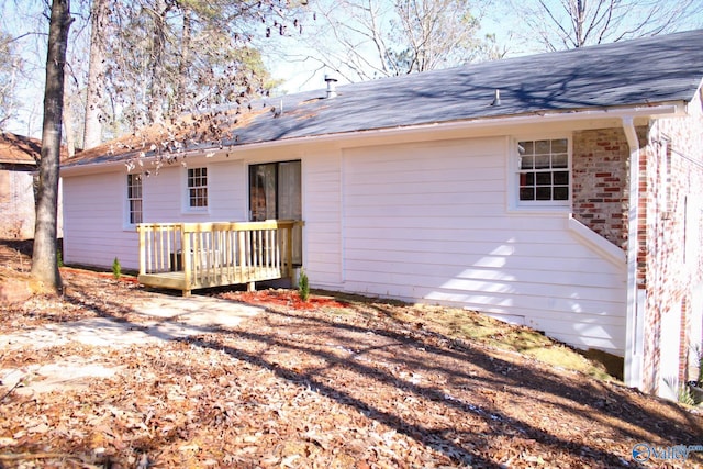 back of property featuring a wooden deck