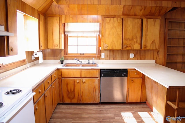 kitchen with light wood-type flooring, stainless steel dishwasher, wood ceiling, wooden walls, and sink