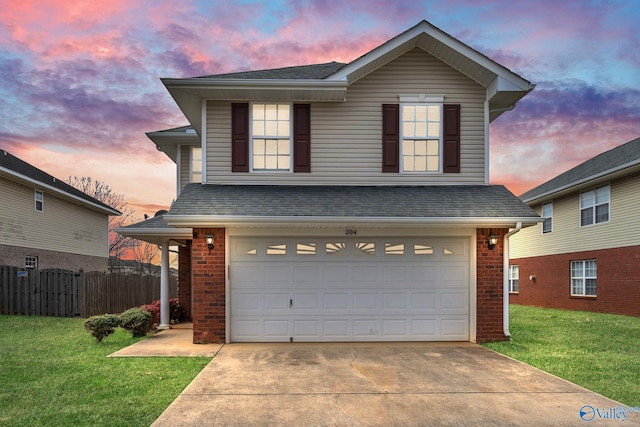 traditional home featuring a front yard, an attached garage, fence, and brick siding