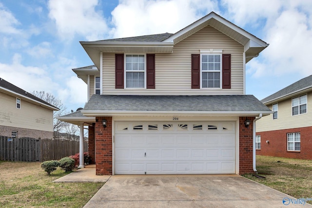 traditional-style house featuring fence, a shingled roof, concrete driveway, a garage, and brick siding