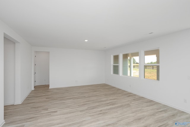 unfurnished room with light hardwood / wood-style flooring