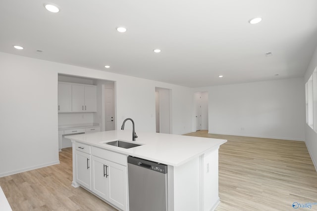 kitchen featuring sink, light hardwood / wood-style flooring, dishwasher, an island with sink, and white cabinets