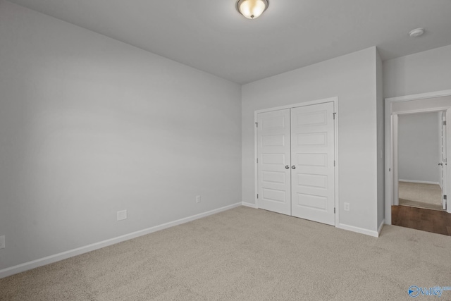 unfurnished bedroom featuring a closet and carpet flooring