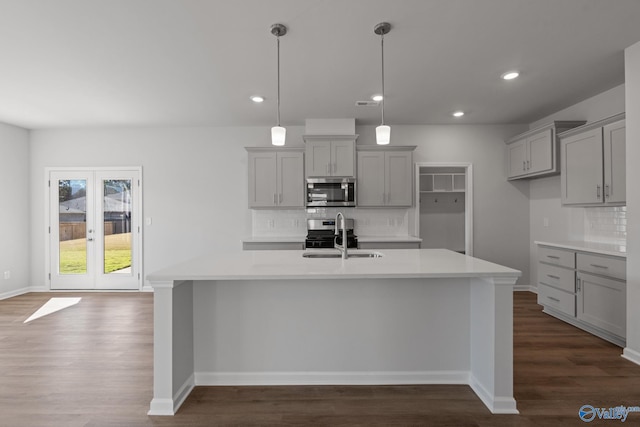 kitchen with sink, gray cabinets, pendant lighting, and stainless steel appliances