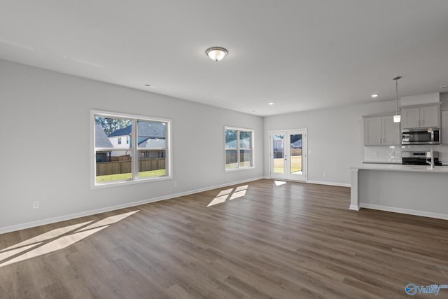 unfurnished living room with dark hardwood / wood-style flooring