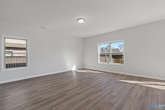 unfurnished room with hardwood / wood-style flooring