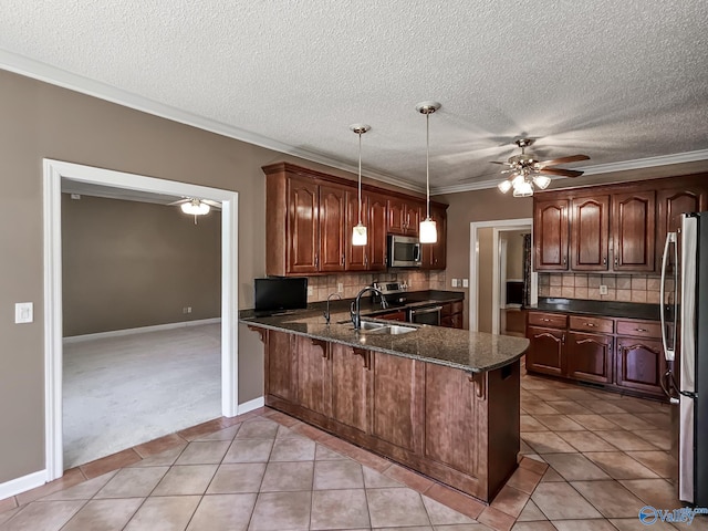 kitchen with light tile patterned floors, stainless steel appliances, kitchen peninsula, and tasteful backsplash