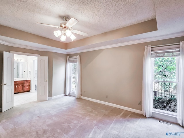 unfurnished bedroom featuring light carpet, multiple windows, and ceiling fan