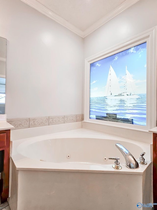 bathroom with vanity, a bathing tub, plenty of natural light, and crown molding