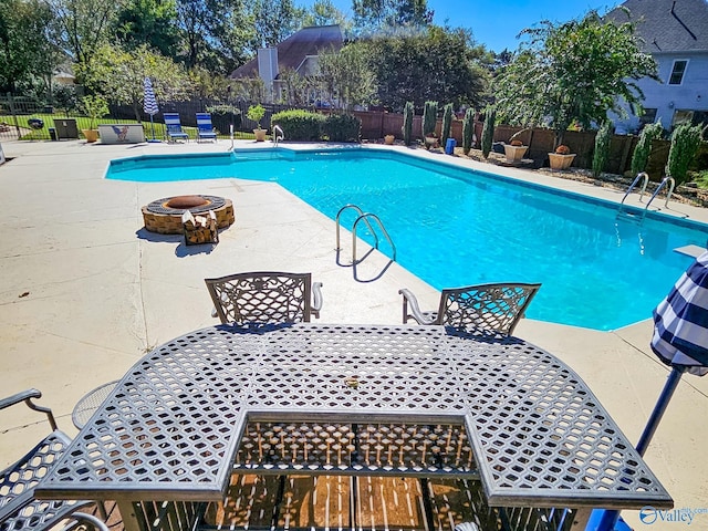 view of pool featuring a patio and an outdoor fire pit