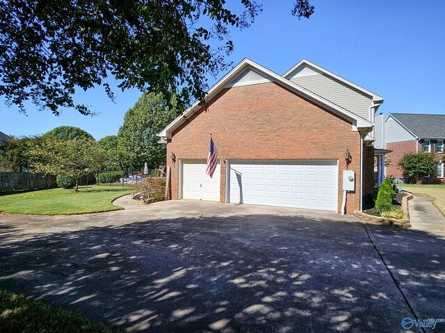 view of property exterior featuring a garage and a lawn