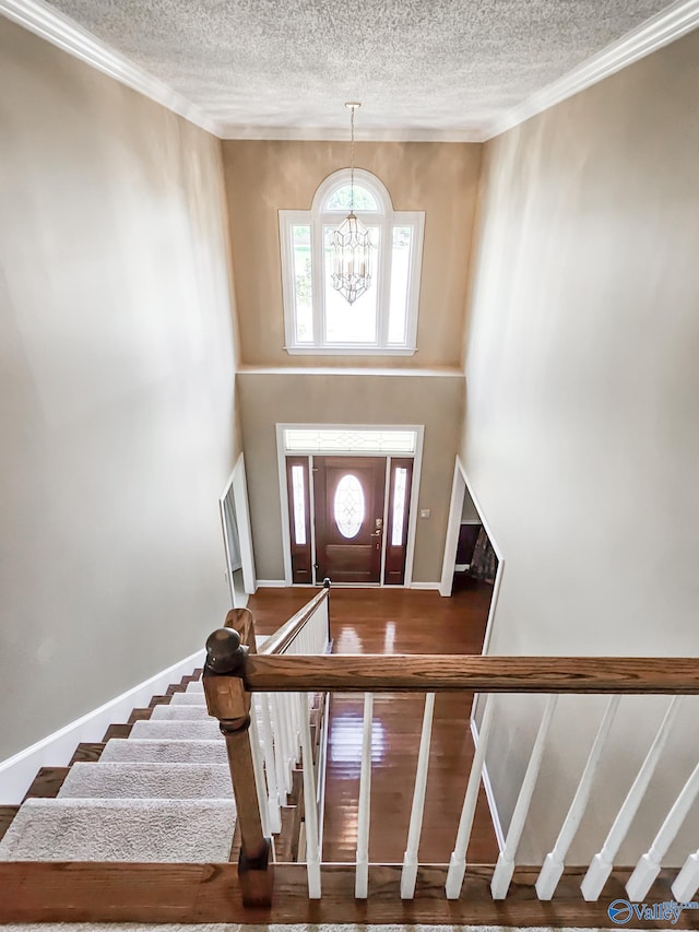 entrance foyer featuring a notable chandelier and a textured ceiling