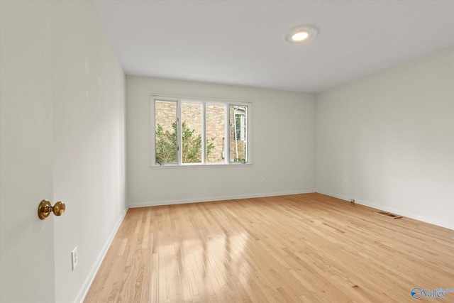 spare room featuring light hardwood / wood-style floors