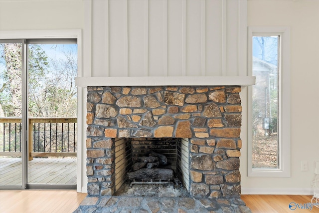 details featuring hardwood / wood-style floors and a stone fireplace