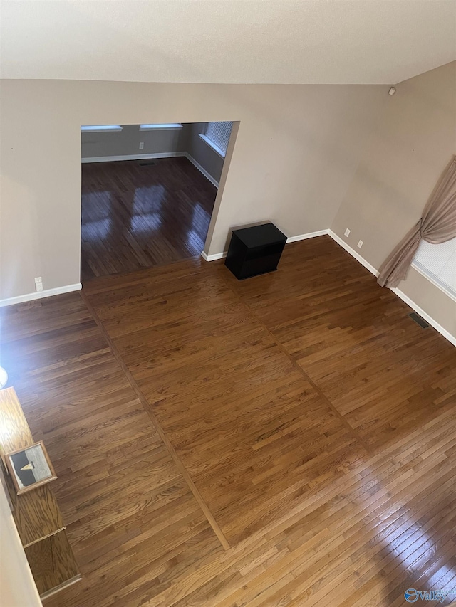 unfurnished living room featuring dark hardwood / wood-style floors