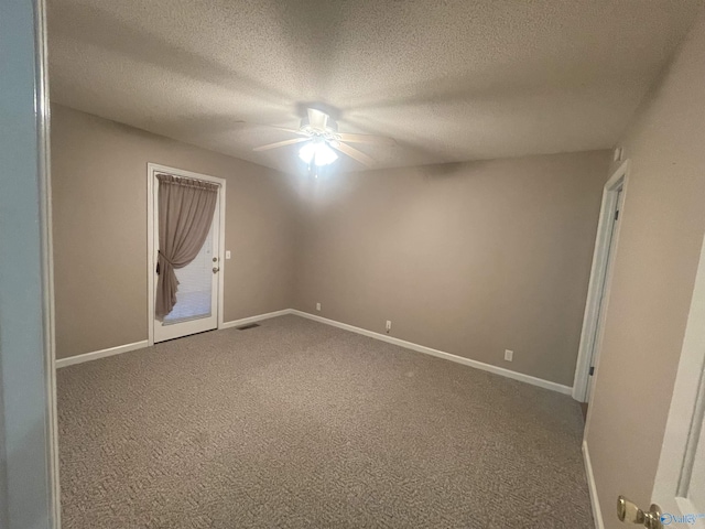 spare room featuring ceiling fan, a textured ceiling, and carpet