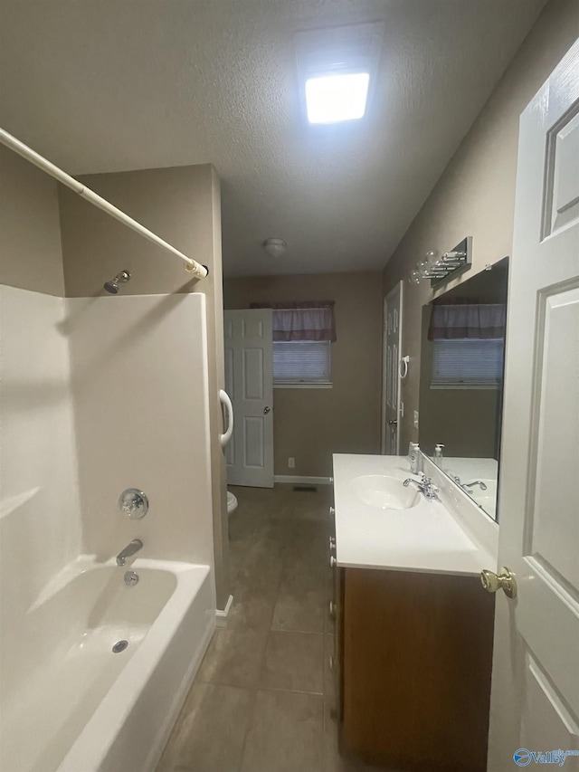 full bathroom with a textured ceiling, tile patterned flooring, vanity, toilet, and shower / bathtub combination