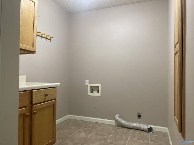 laundry area featuring a textured ceiling, washer hookup, electric dryer hookup, cabinets, and light tile patterned flooring