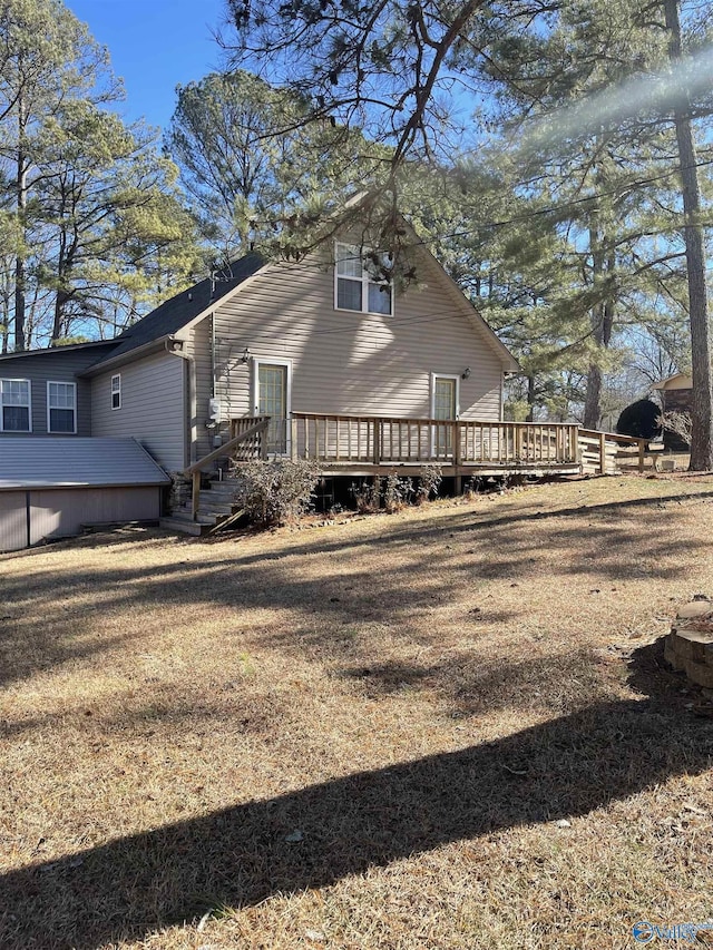 view of property exterior with a wooden deck and a yard