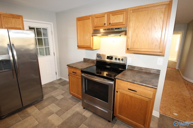 kitchen with dark countertops, baseboards, stainless steel appliances, and under cabinet range hood