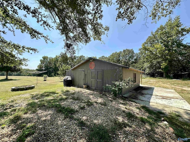 view of home's exterior featuring an outbuilding and a yard