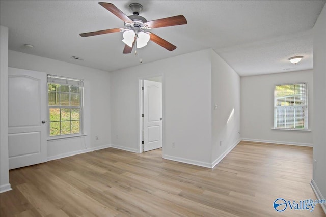 215 Shadow Ct SW, Huntsville, AL 35824 - spare room with light wood finished floors, plenty of natural light, a ceiling fan, and a textured ceiling