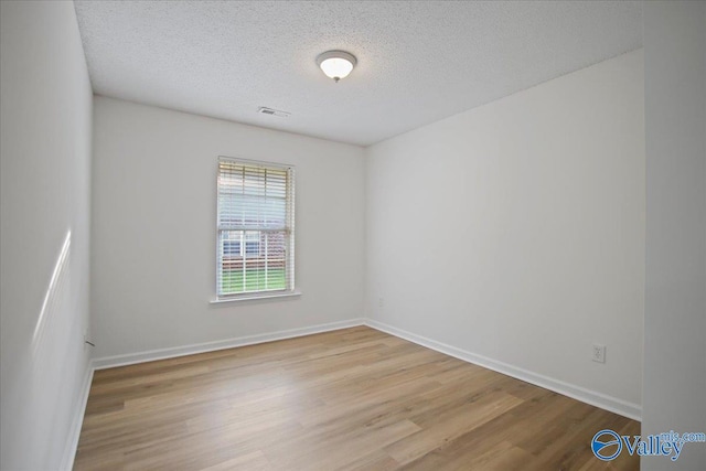 215 Shadow Ct SW, Huntsville, AL 35824 - unfurnished room with wood finished floors and a textured ceiling
