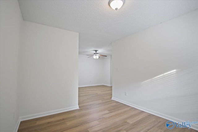 215 Shadow Ct SW, Huntsville, AL 35824 - spare room featuring a ceiling fan, wood finished floors, and a textured ceiling