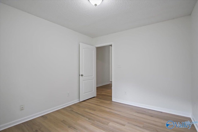215 Shadow Ct SW, Huntsville, AL 35824 - unfurnished room featuring light wood-style floors and a textured ceiling