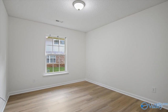215 Shadow Ct SW, Huntsville, AL 35824 - empty room featuring wood finished floors and a textured ceiling