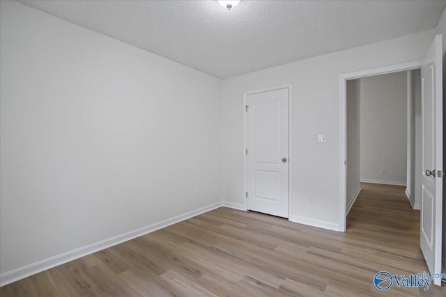 215 Shadow Ct SW, Huntsville, AL 35824 - unfurnished bedroom with wood finished floors and a textured ceiling