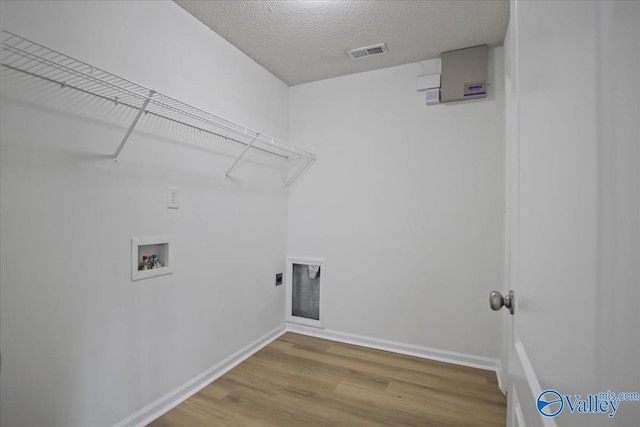 215 Shadow Ct SW, Huntsville, AL 35824 - washroom featuring washer hookup, wood finished floors, and a textured ceiling