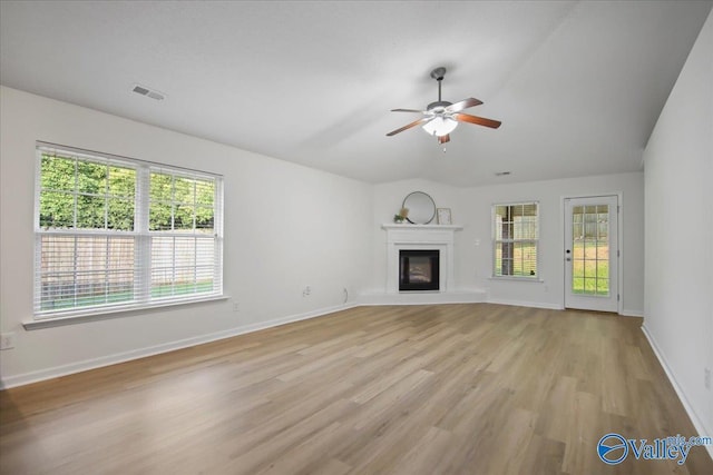 215 Shadow Ct SW, Huntsville, AL 35824 - unfurnished living room with a ceiling fan, light wood-type flooring, and a glass covered fireplace