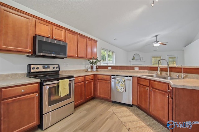 215 Shadow Ct SW, Huntsville, AL 35824 - kitchen with appliances with stainless steel finishes, light wood-style flooring, a ceiling fan, lofted ceiling, and light countertops