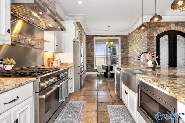 24188 Newby Rd, Madison, AL 35756 - kitchen featuring stone tile floors, a sink, wall chimney exhaust hood, appliances with stainless steel finishes, and white cabinetry
