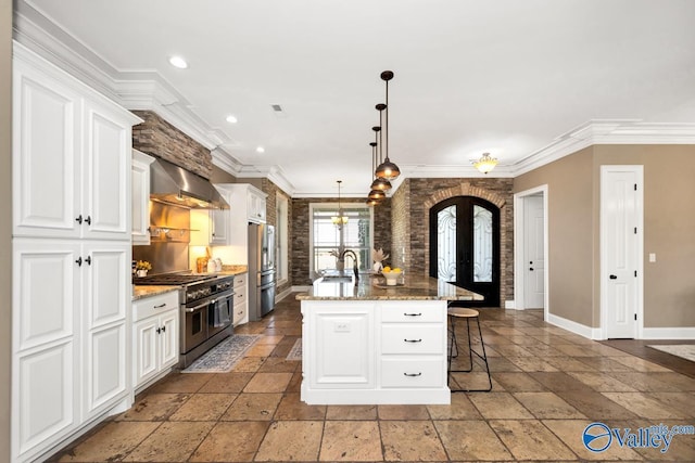 24188 Newby Rd, Madison, AL 35756 - kitchen with stone tile floors, french doors, appliances with stainless steel finishes, and wall chimney range hood