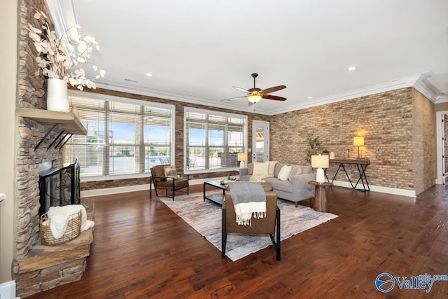 24188 Newby Rd, Madison, AL 35756 - living area with a stone fireplace, wood finished floors, a ceiling fan, ornamental molding, and baseboards