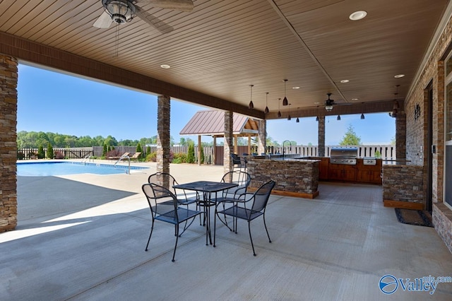 24188 Newby Rd, Madison, AL 35756 - view of patio / terrace featuring fence private yard, an outdoor kitchen, a fenced in pool, area for grilling, and ceiling fan