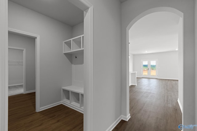 mudroom with dark wood-type flooring and french doors