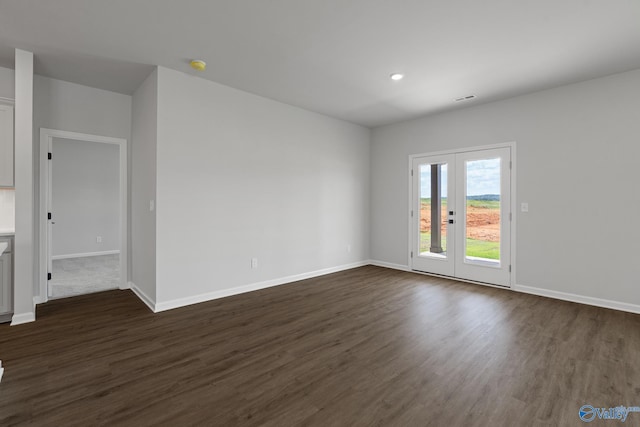 unfurnished room with dark wood-type flooring and french doors