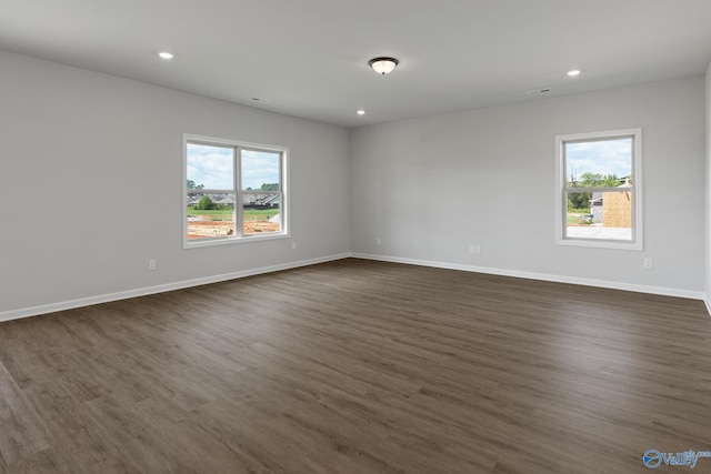 spare room with dark hardwood / wood-style flooring