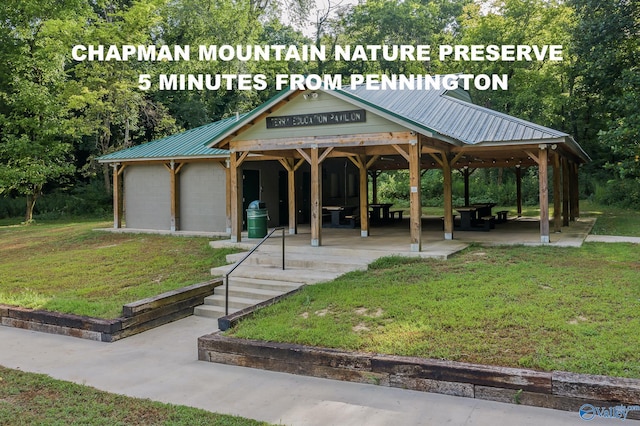 view of property's community featuring a gazebo, a patio, and a lawn