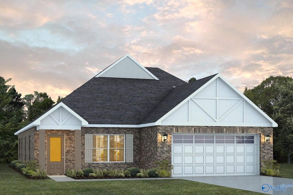 view of front facade with a garage and a yard