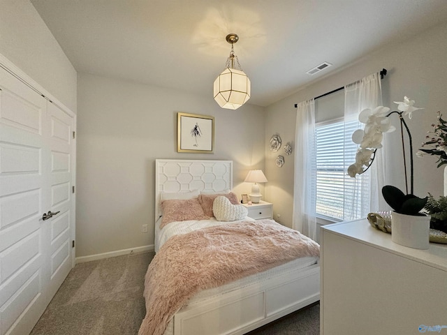 bedroom featuring baseboards, visible vents, and carpet