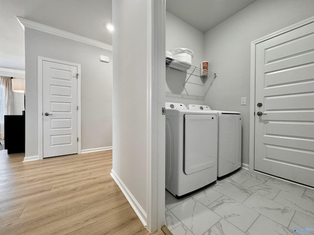 laundry room with crown molding, washing machine and clothes dryer, laundry area, marble finish floor, and baseboards