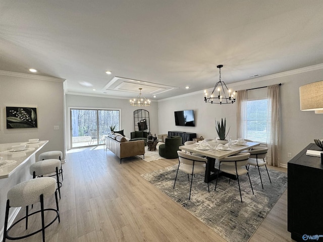 dining room with ornamental molding, recessed lighting, a notable chandelier, and light wood finished floors